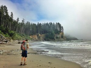 a hammock camper standing on the beach of Olympic National Park